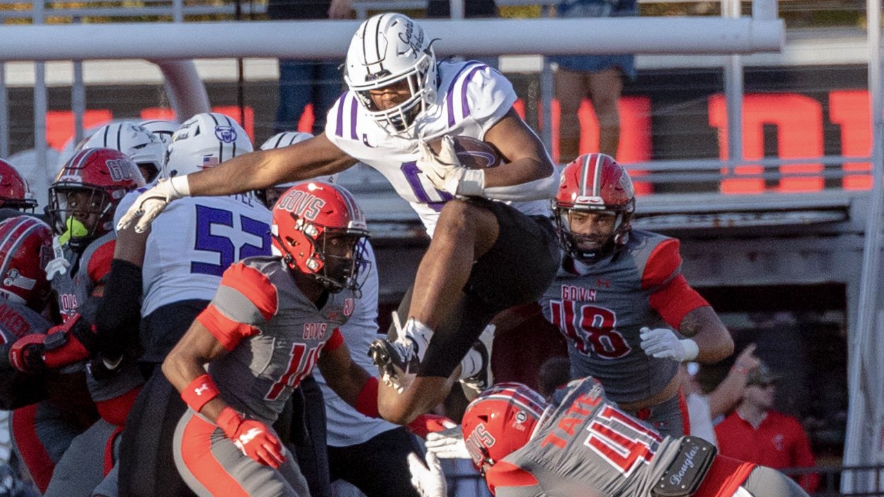UCA Bears running back Landen Chambers hurdles a tackler in a game against the Austin Peay Governors