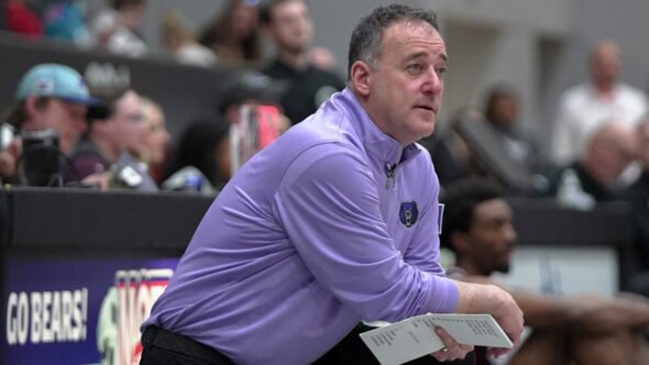 UCA Bears coach John Shulman kneeling on the sidelines in game against Eastern Kentucky